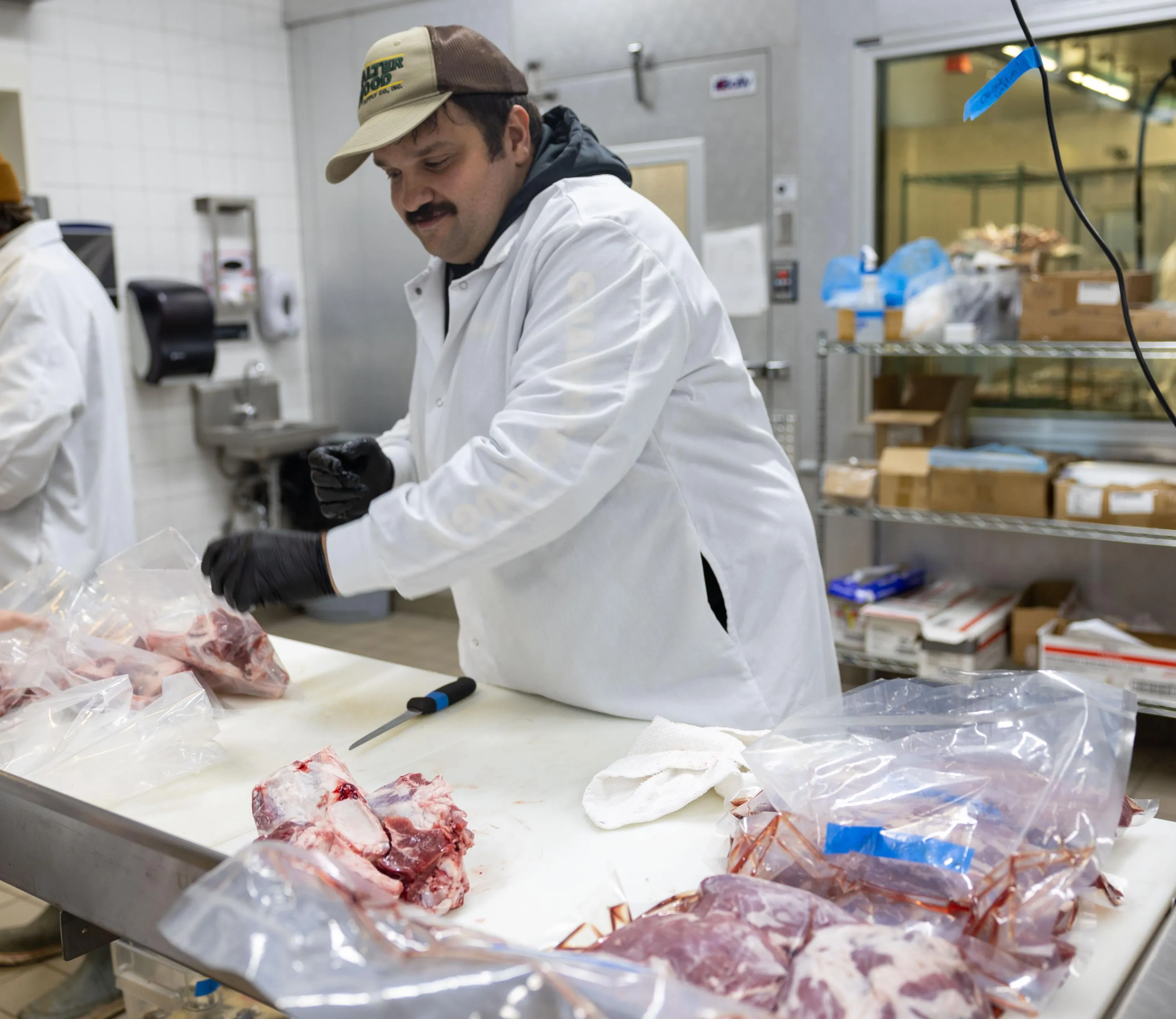 Artisanal Butchery Program student Robert Moreland packaging cuts of meat during class.
