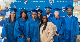people in blue caps and gowns smiling