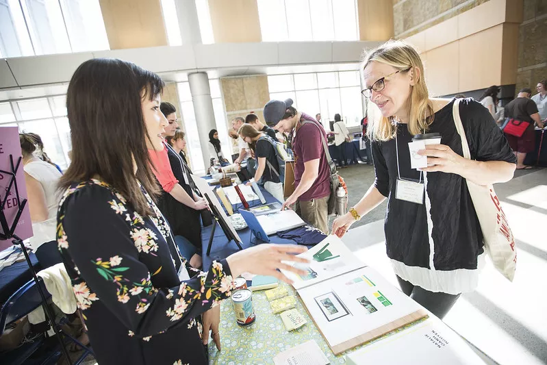 Two people speaking together at event