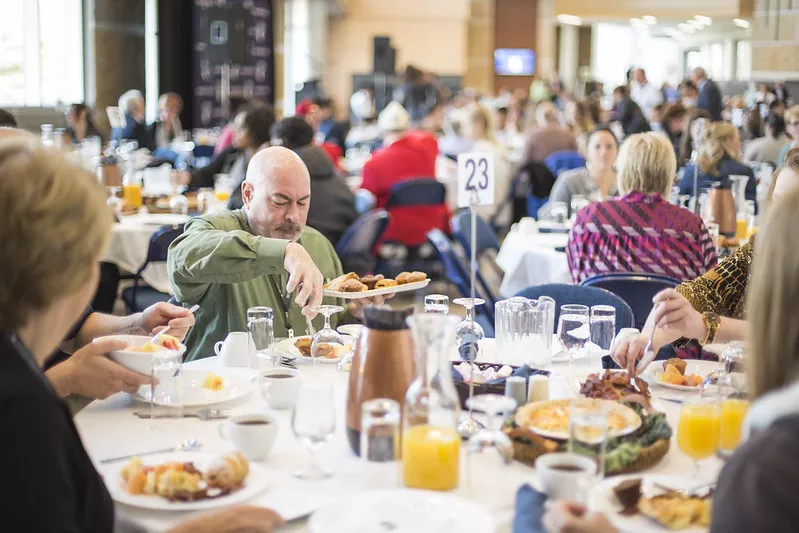 people sitting around a table of food