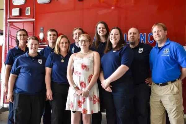 Ten EMT students stand together. 