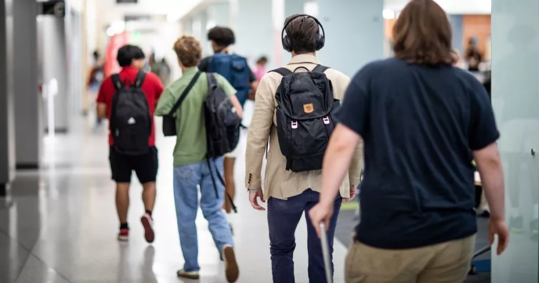 Madison College students walking in the Truax campus hallway.