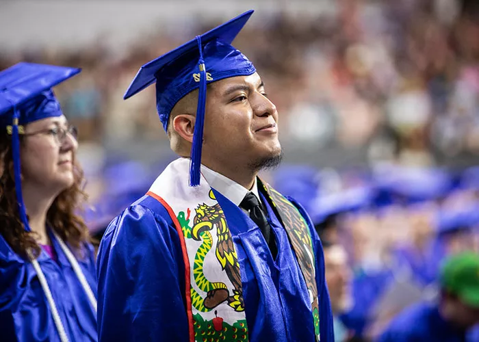 photo: recent Madison College graduate in cap and gown