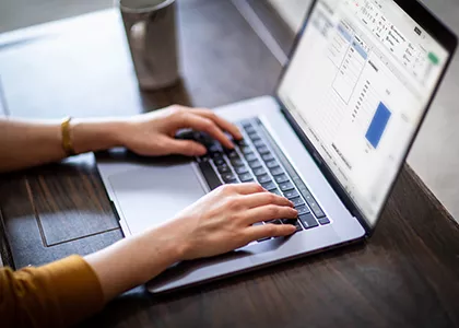 hands on laptop keyboard