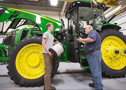 Instructor and Student Working on Tractor