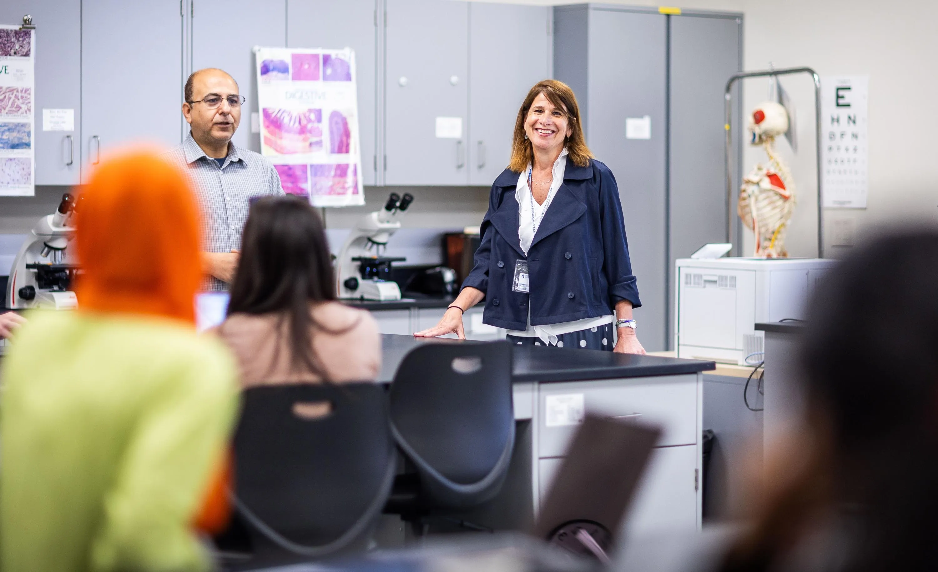 President Berne standing in a health science class talking with students. 