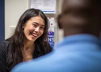 Woman smiling at a man