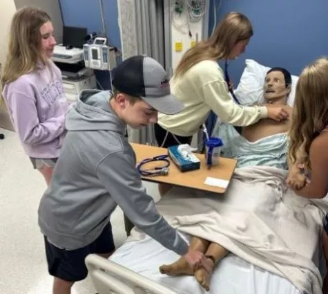 Madison College summer camp students learn in a nursing lab.