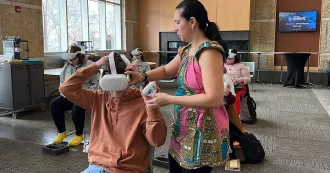 Caroline Bailey assisting students with VR in Spanish class