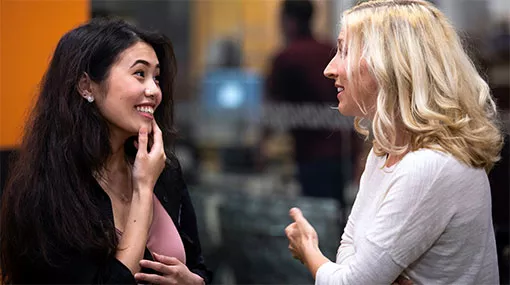 two people speaking enthusiastically