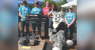 Metal Mania first place winners pose with Wolfie.