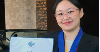 Photo of Ruiqi Zeng holding an award certificate.