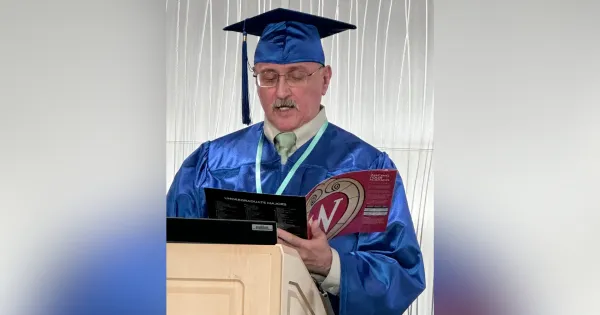 Madison College Robert Zapata giving a speech at the podium during the Dec. 17 graduation ceremony.