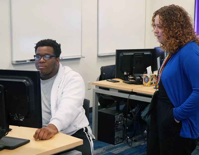 cyber compliance student and instructor discussing Python scripting