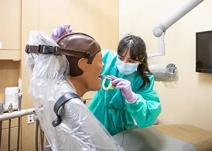 dental student working on a simulated patient