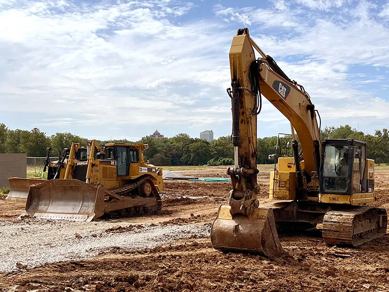 bulldozers and a backhoe at a construction site