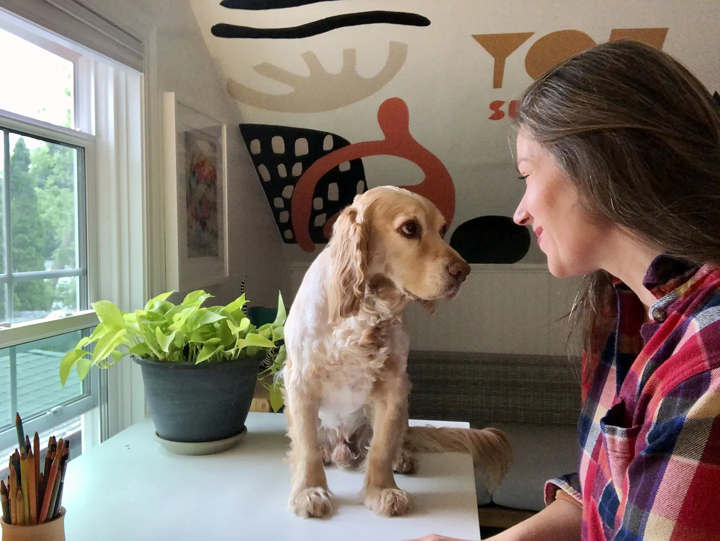 Madison College graphic artist instructor Courtney Dicmas looking into the eye of her dog, Charlie.