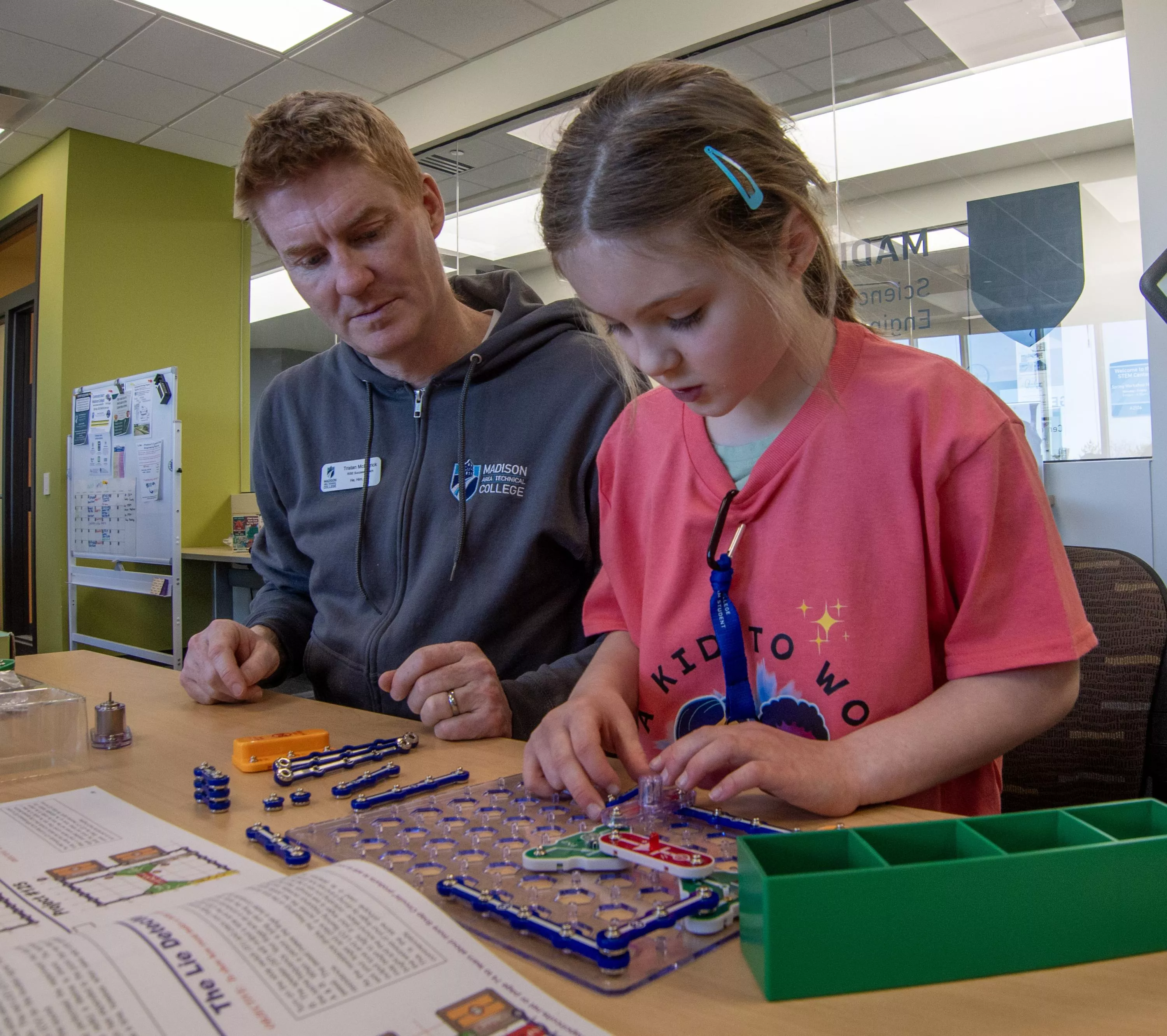 A Madison College staff member with child.