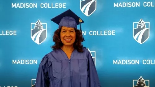 Elsa Arellano wears a cap and gown.