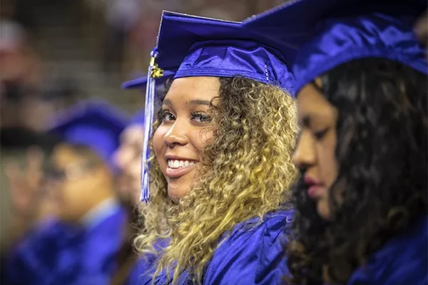 student in cap and gown at graduation