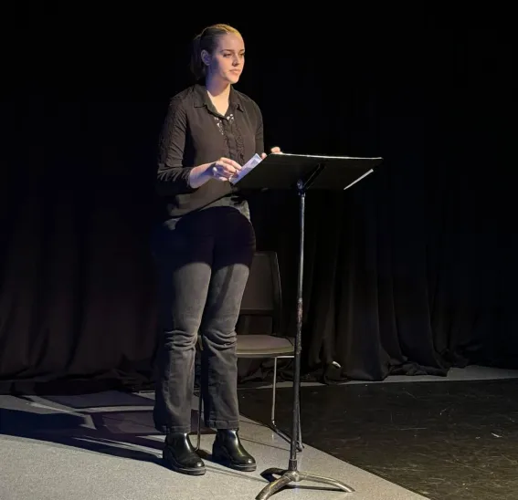 Student reading from a podium