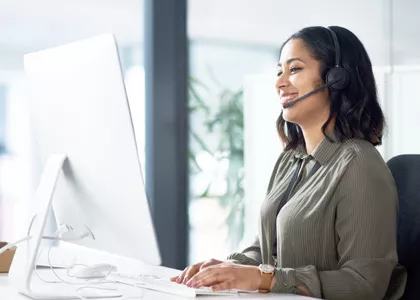 Person on a computer, assisting a customer through a headset