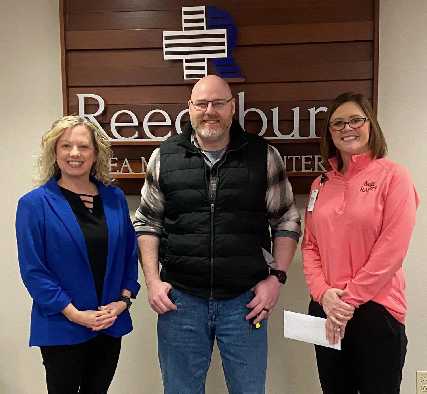 Jake Griebe poses for a photo with Madison College Reedsburg staff.
