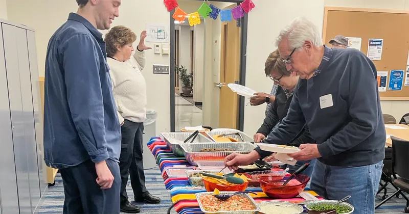 Community members at Spanish-speaking potluck dinner