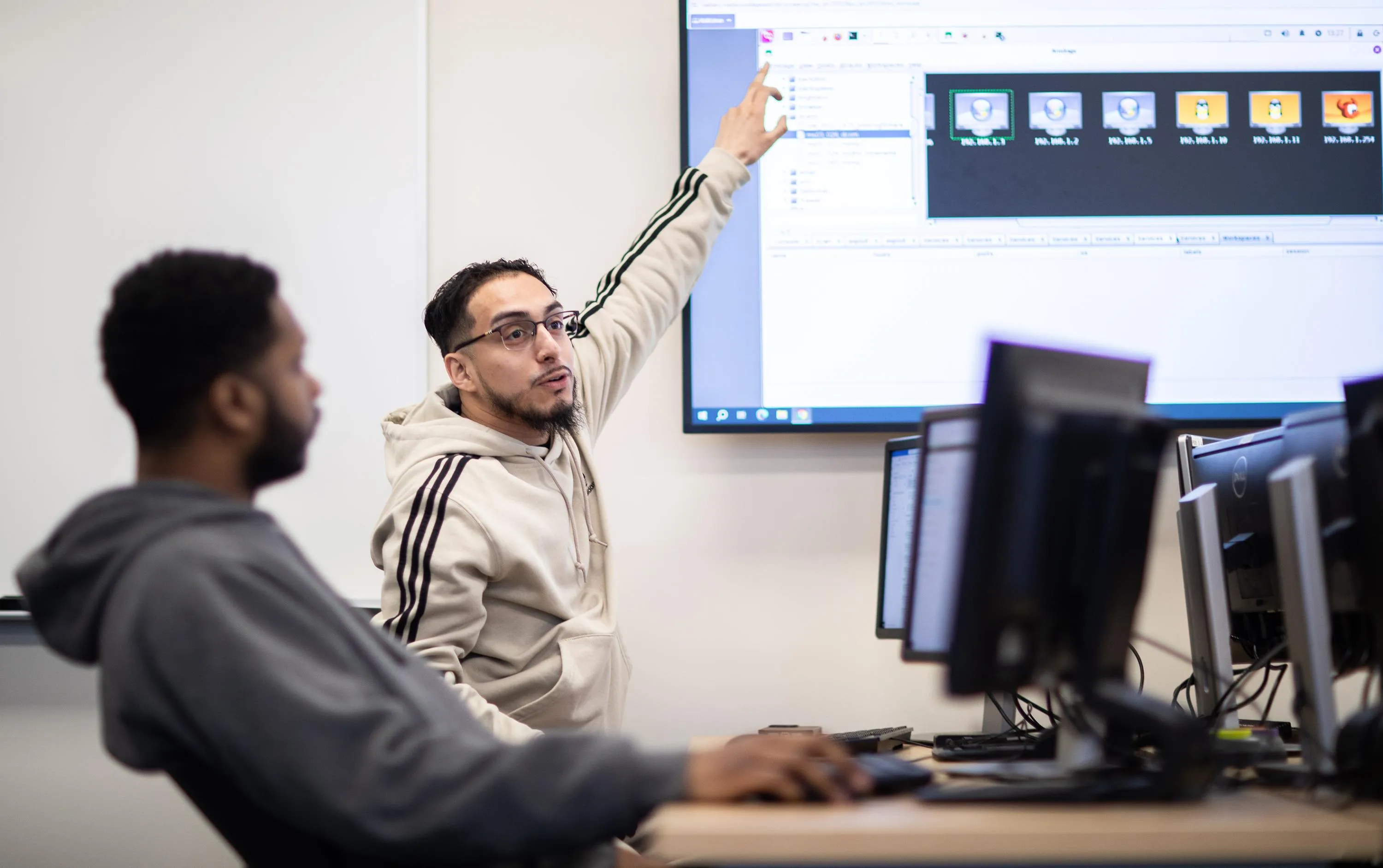 Student presenting in front of digital board in class.