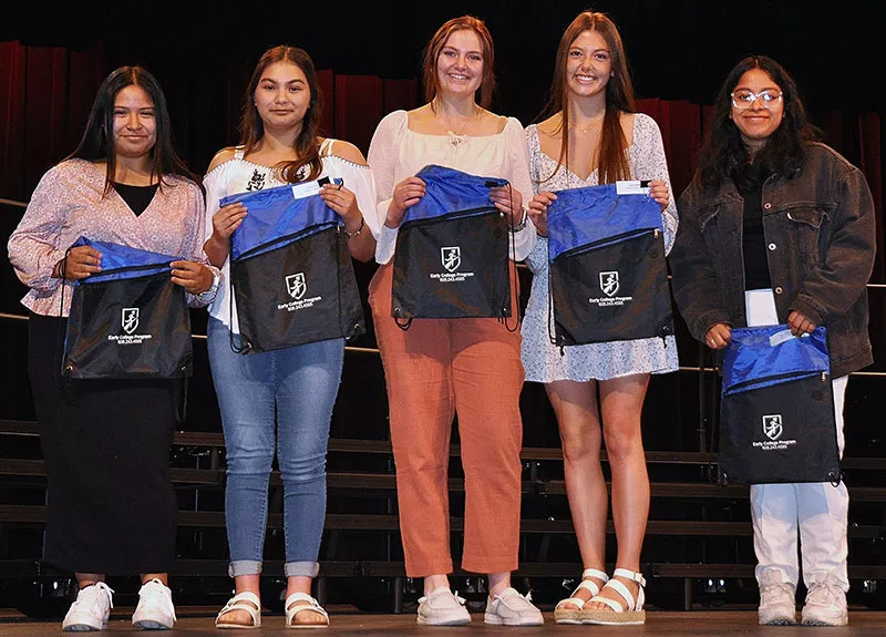 Jefferson High School graduates holding Madison College Earl College book bags