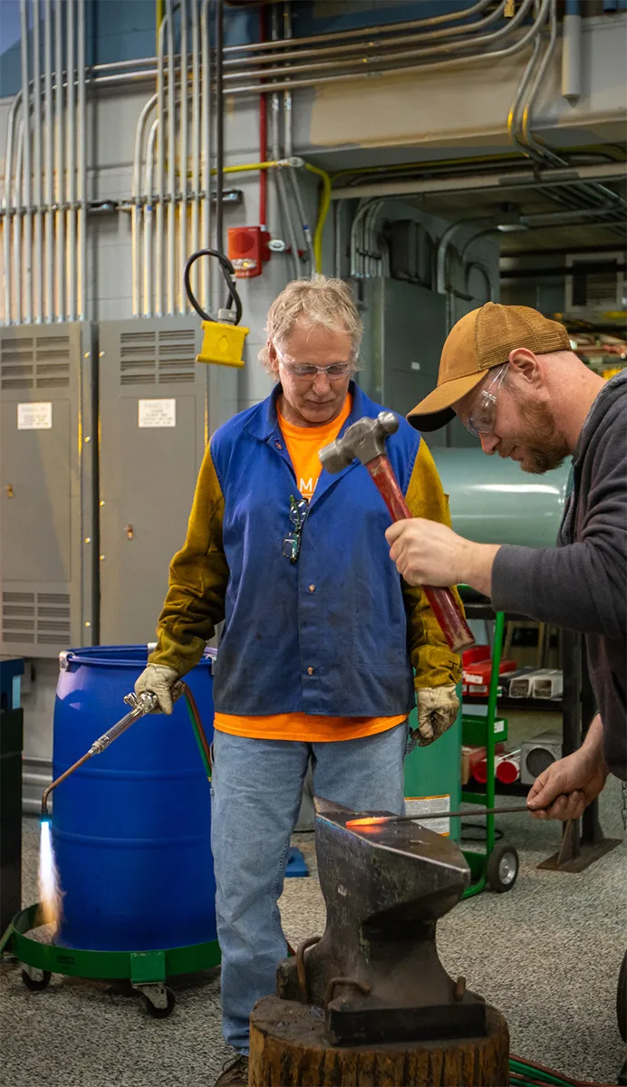 Welding instructor Jimmy DiGidio holding blow torch