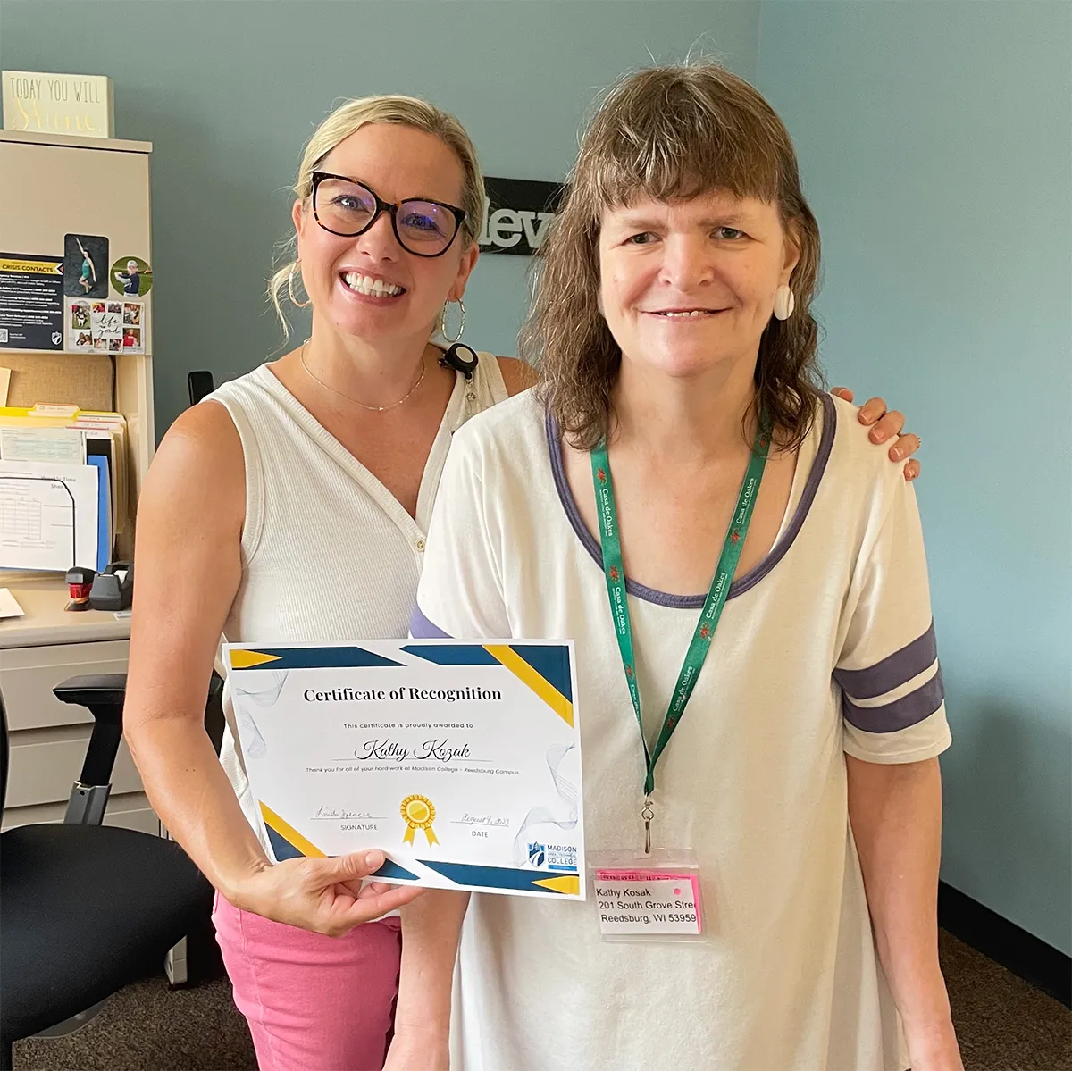 Linda Spencer and Kathy smiling and holding up certificate