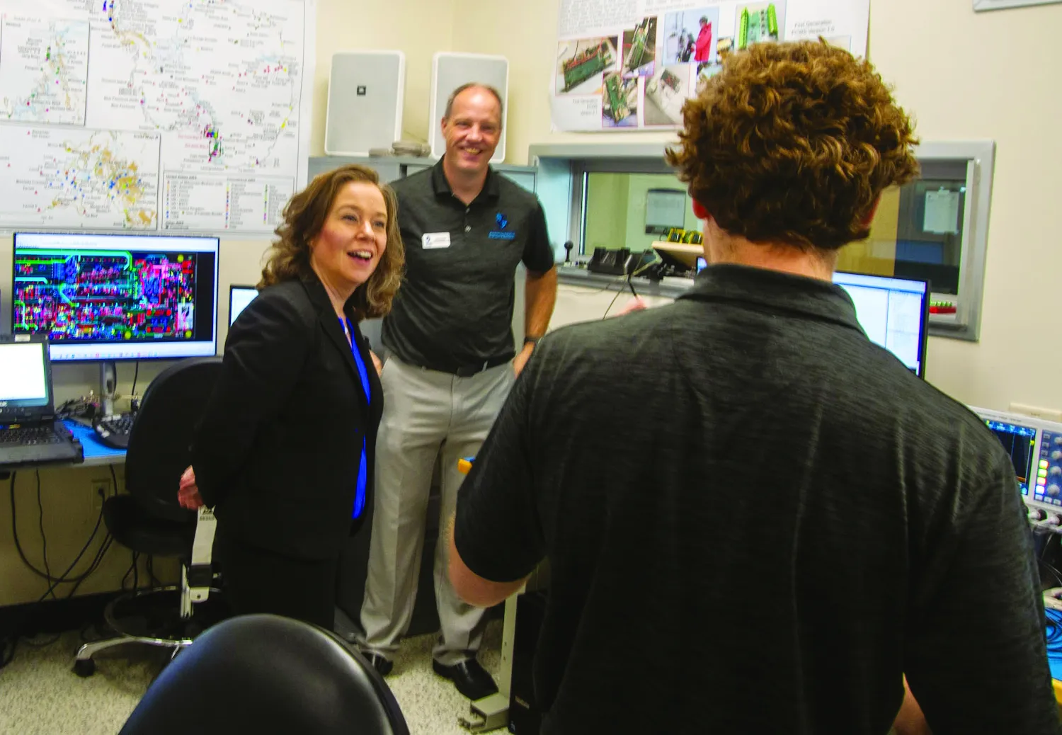 Lt. Gov. Sara Rodriquez talks with faculty member while another faculty members listens.