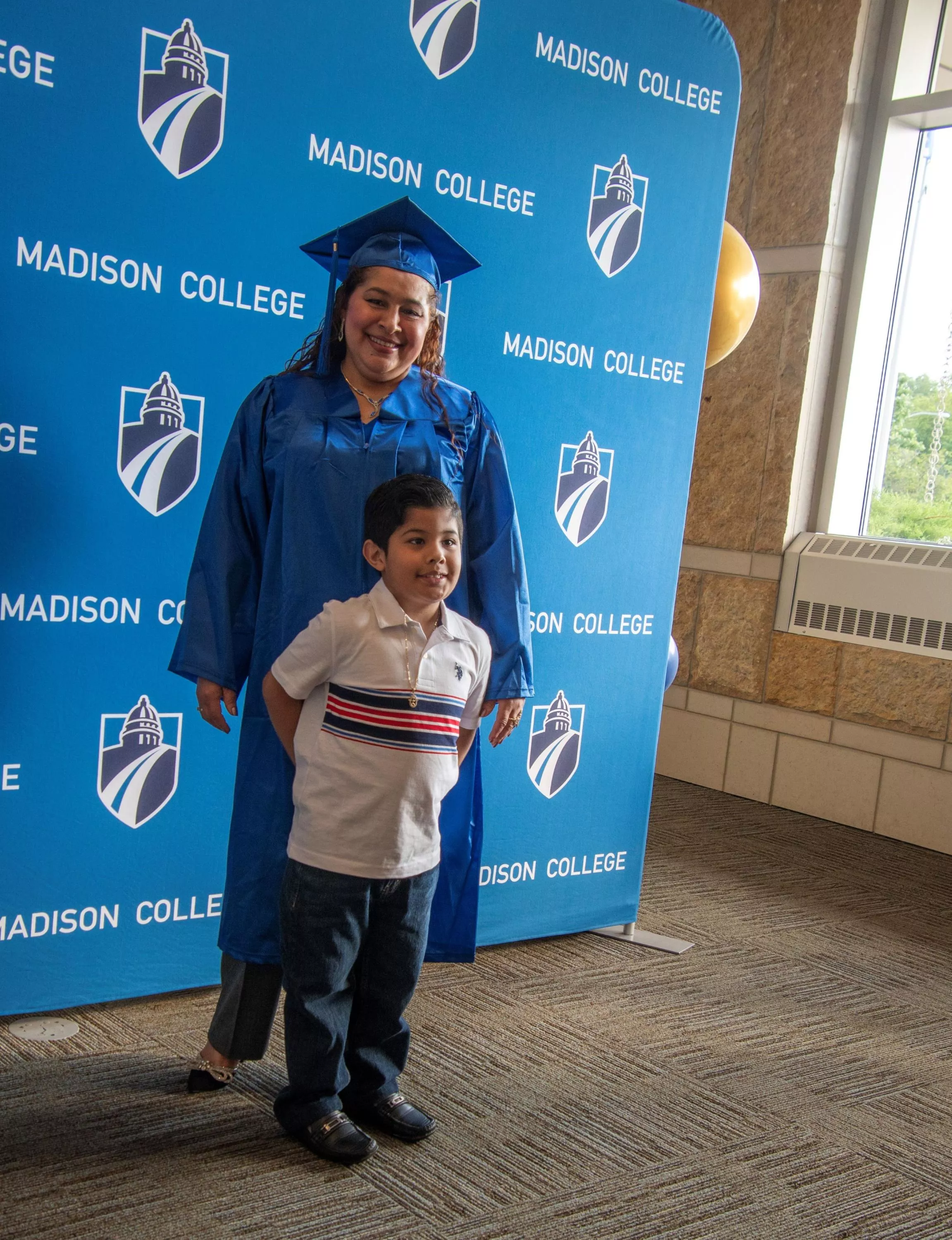 Madison College grad with child