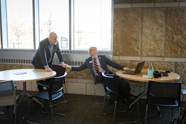 Two people talking between two tables
