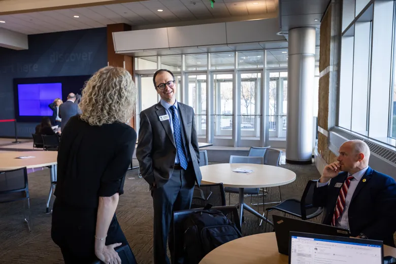 Three people engaged in conversation