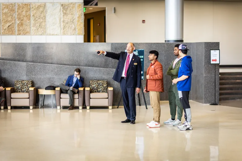 A person standing and pointed while others look on 