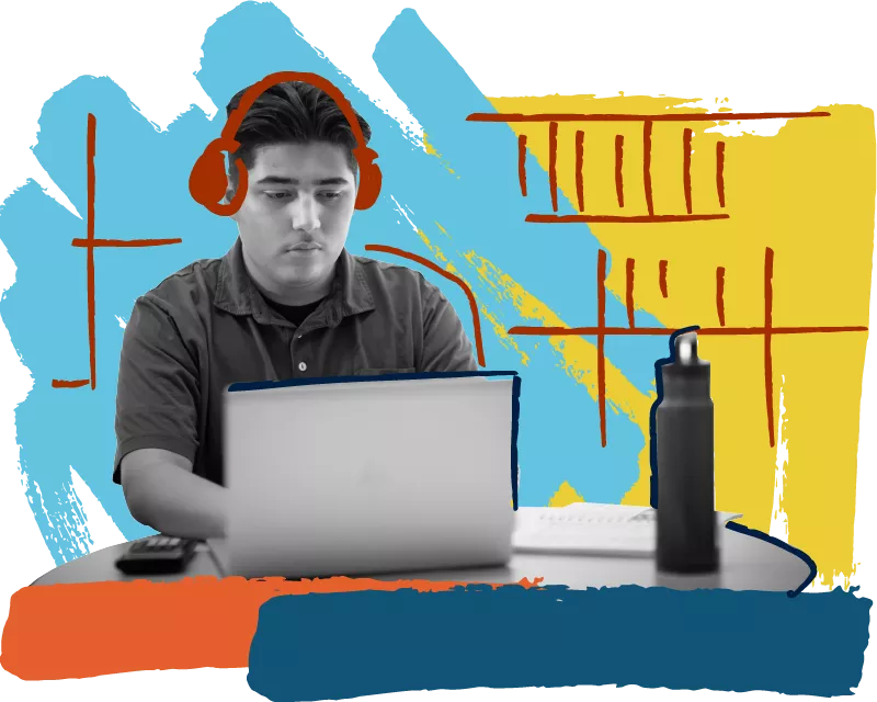 Madison College student wearing headphones using a laptop