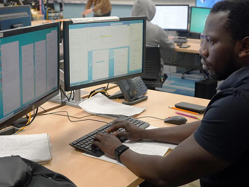 Momodou Lamin J, information technology student working in class