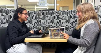 Daughter and mother studying together at a table