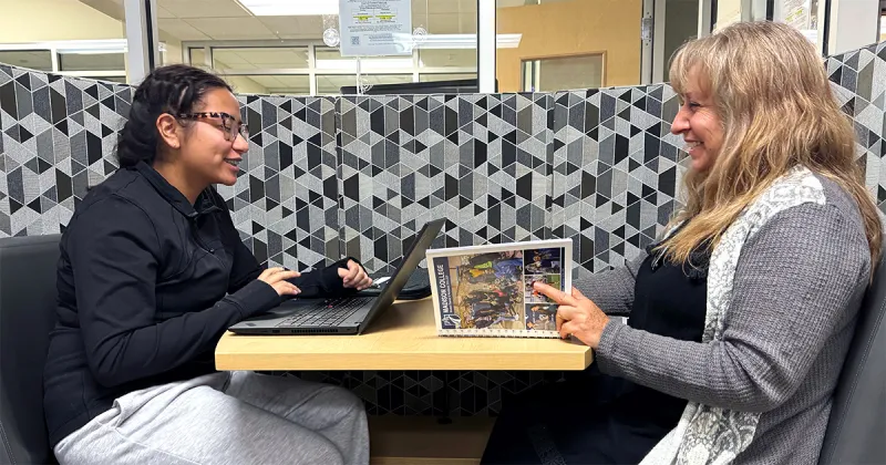 Daughter and mother studying together at a table
