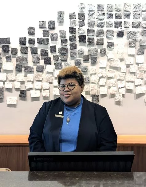 Nat Mason at their front desk supervisor position at the AC Hotel in downtown Madison.