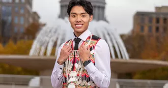 Madison College student Nathan Xiong poses wearing traditional Hmong clothing.