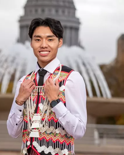 A photo of student Nathan Xiong posing in traditional Hmong clothing.