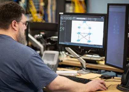 student in Cisco Networking class learning to configure a router and a switch for basic functionality