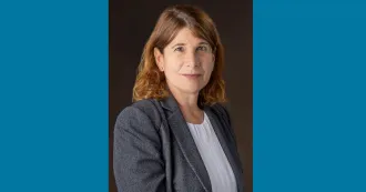 Photo of President Berne, portrait style, wearing gray blazer and white blouse.