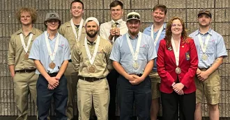 Students pose with their SkillsUSA national competition medals around their necks.