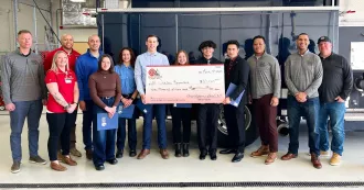 Local 311 fire fighters present students and staff with $10,000 check