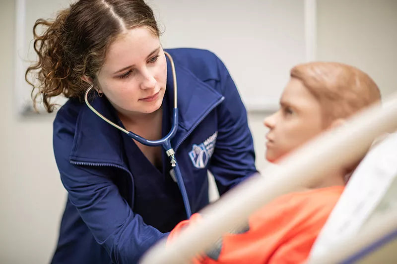 nursing student listening with a stethoscope
