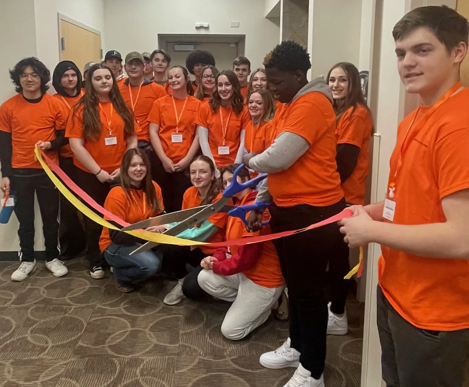 Mini Manufacturing World event with student participants cutting a ribbon during the event.